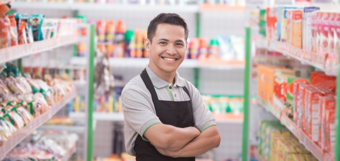 A grocery store manager examines shopper product selection