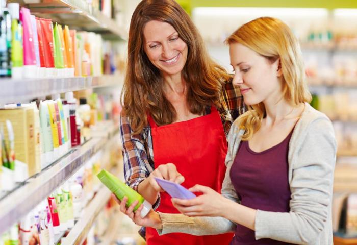 A grocery store manager examines shopper product selection